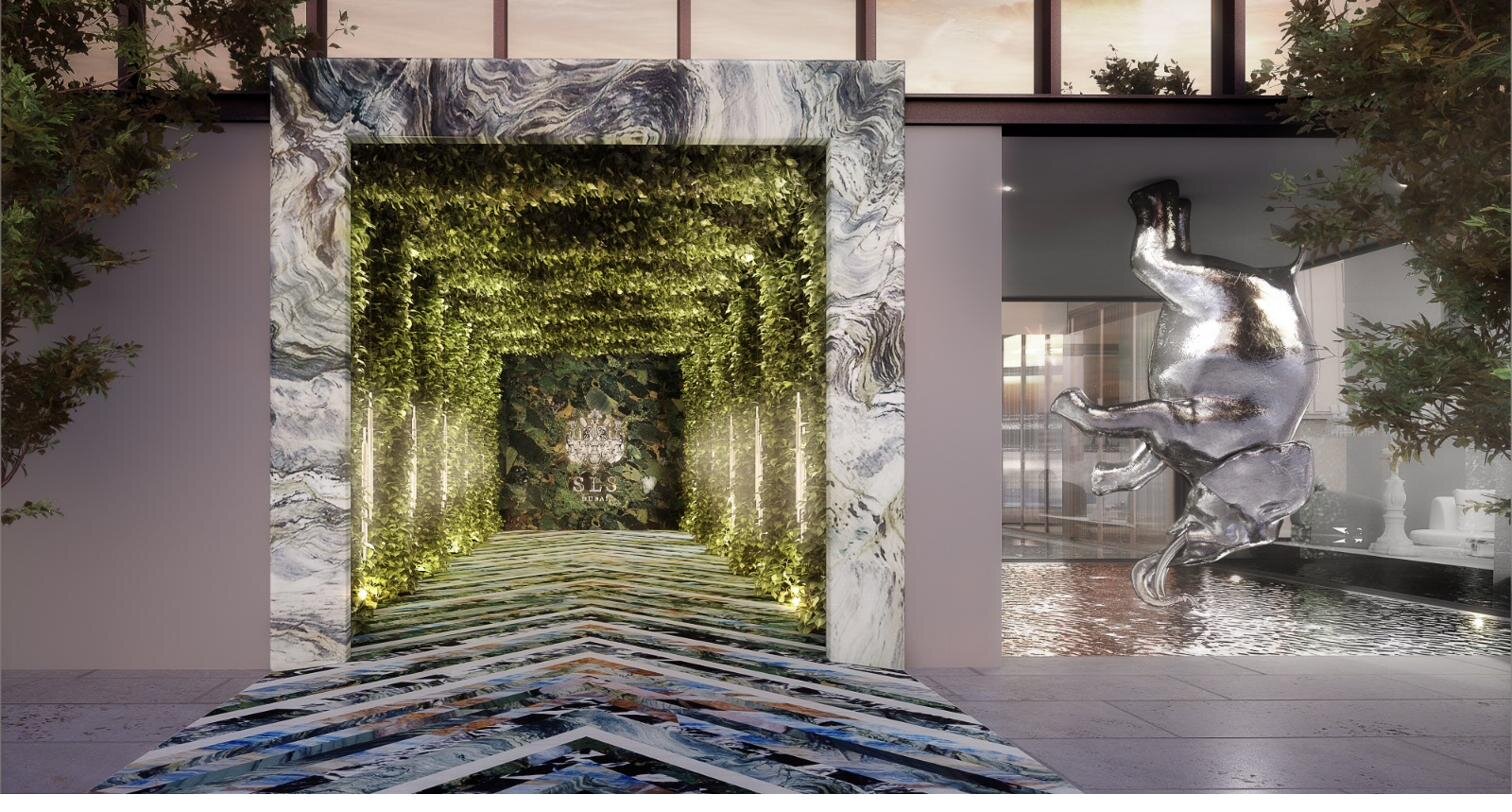 Grand arrival lobby with marble portal and verdant interior